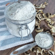 A jar of cream of mushroom soup mix with a spoon next to it.