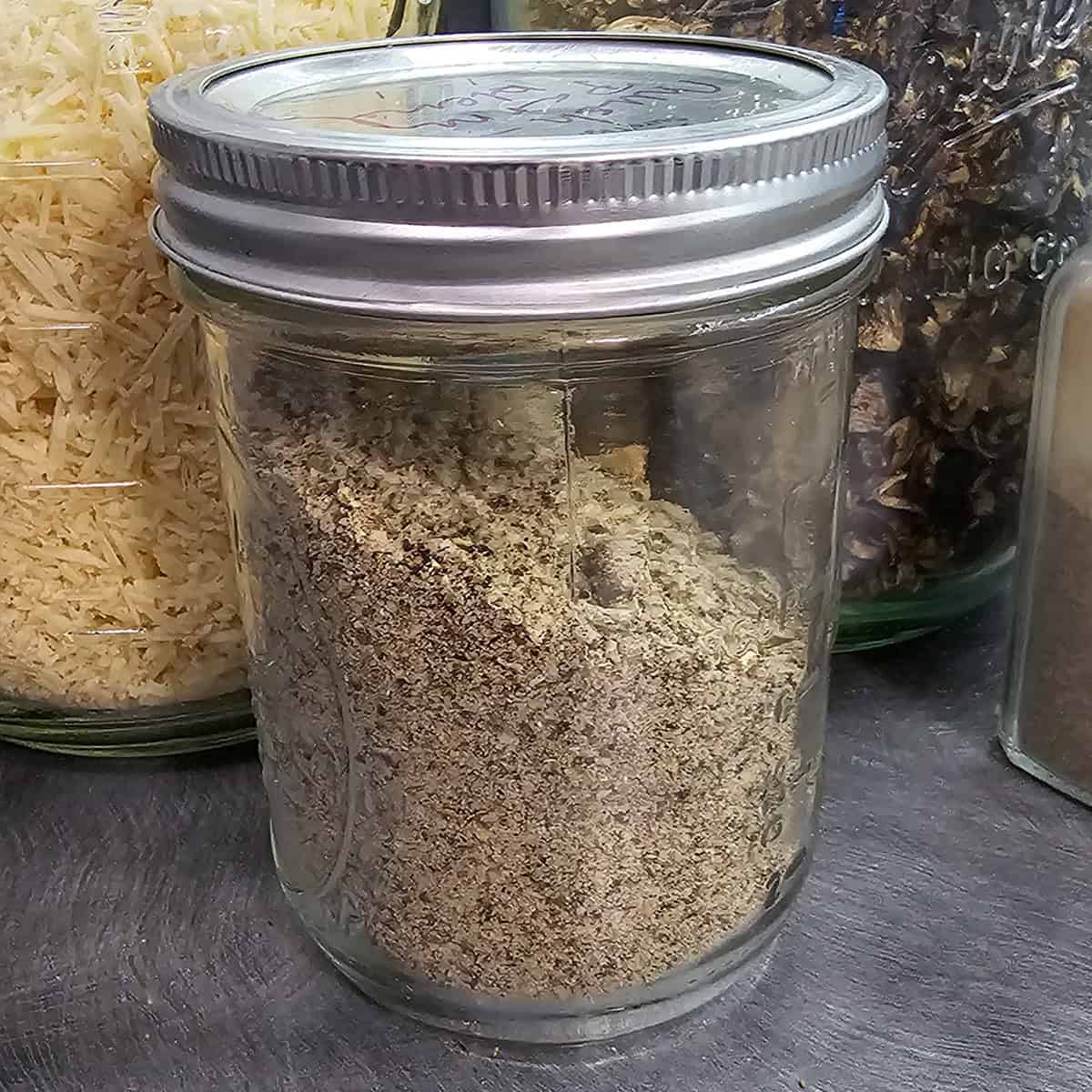 Canning jar full of a diy mushroom parmesan seasoning blend.